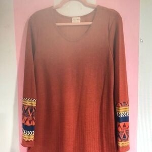 Elegant Rust Long Sleeve Top with Patterned Cuffs